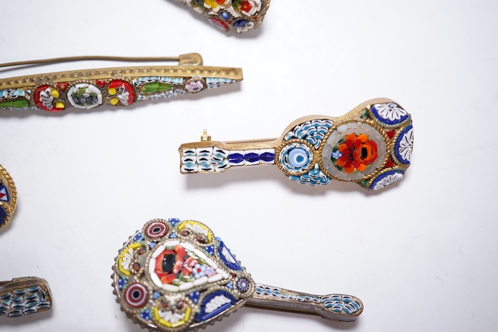 A collection of twenty-eight micro-mosaic brooches, including ten banjo and guitars shaped brooches, six similar large oval brooches, nine small brooches and three long brooches. (28) Condition - good